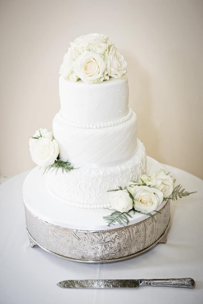 Elegant ivory wedding cakes with gilded gold details